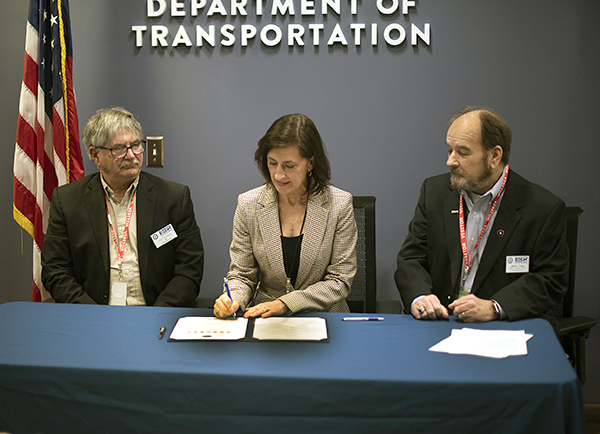 Photo: Nancy Daubenberger signing a document